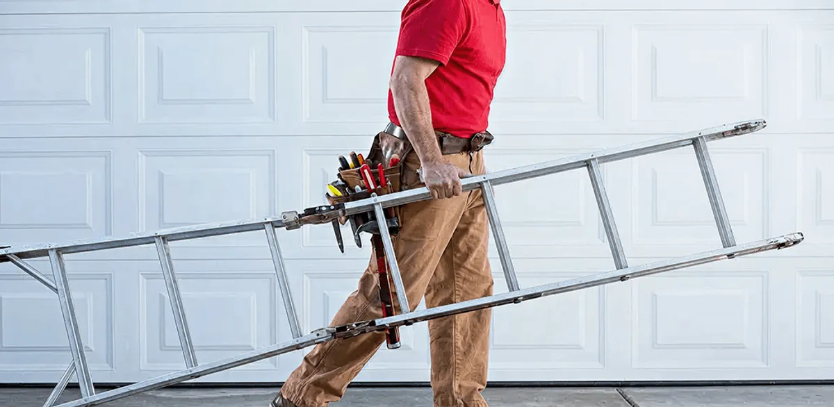 Garage door repair technician arriving with tools and ladder in Louisville, KY